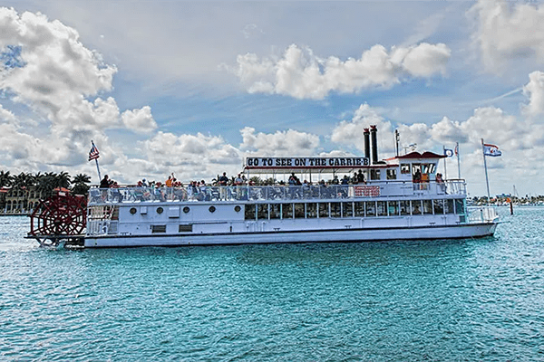 A large white boat floating on top of the water.