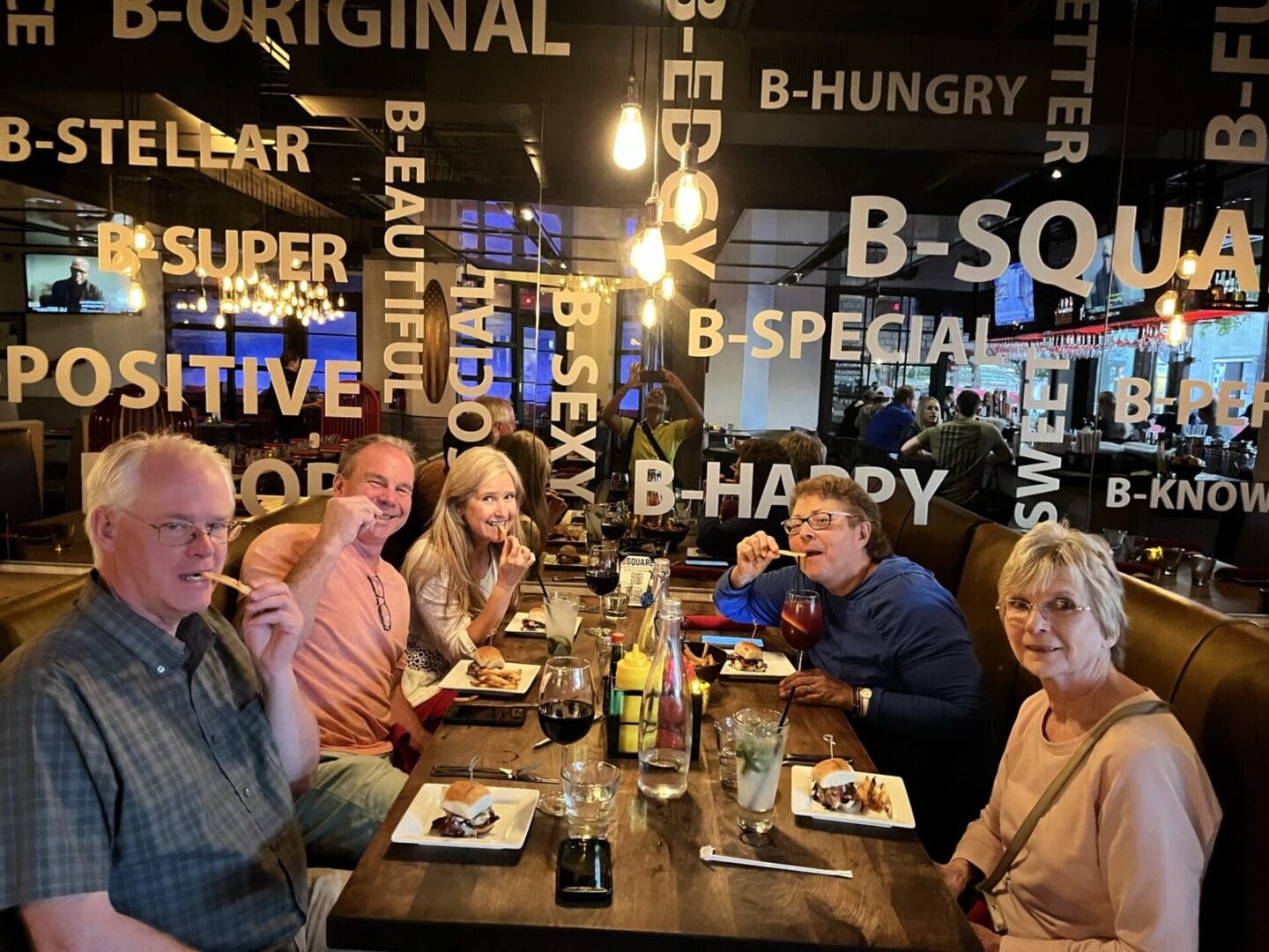 A group of people sitting at a table with plates.