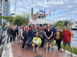 Group of people on a food tour by a boat.